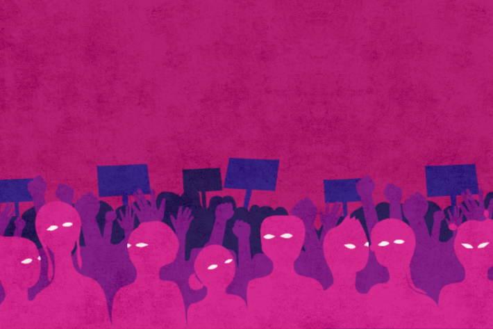 a crowd of people holding signs in front of a pink background.
