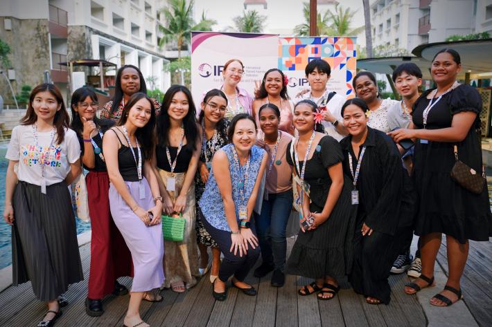 A group of women from diverse contexts posing for a photo