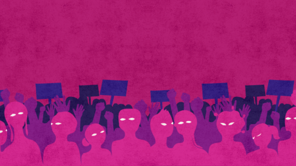 a crowd of people holding signs in front of a pink background.