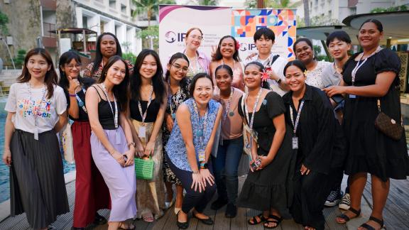 A group of women from diverse contexts posing for a photo